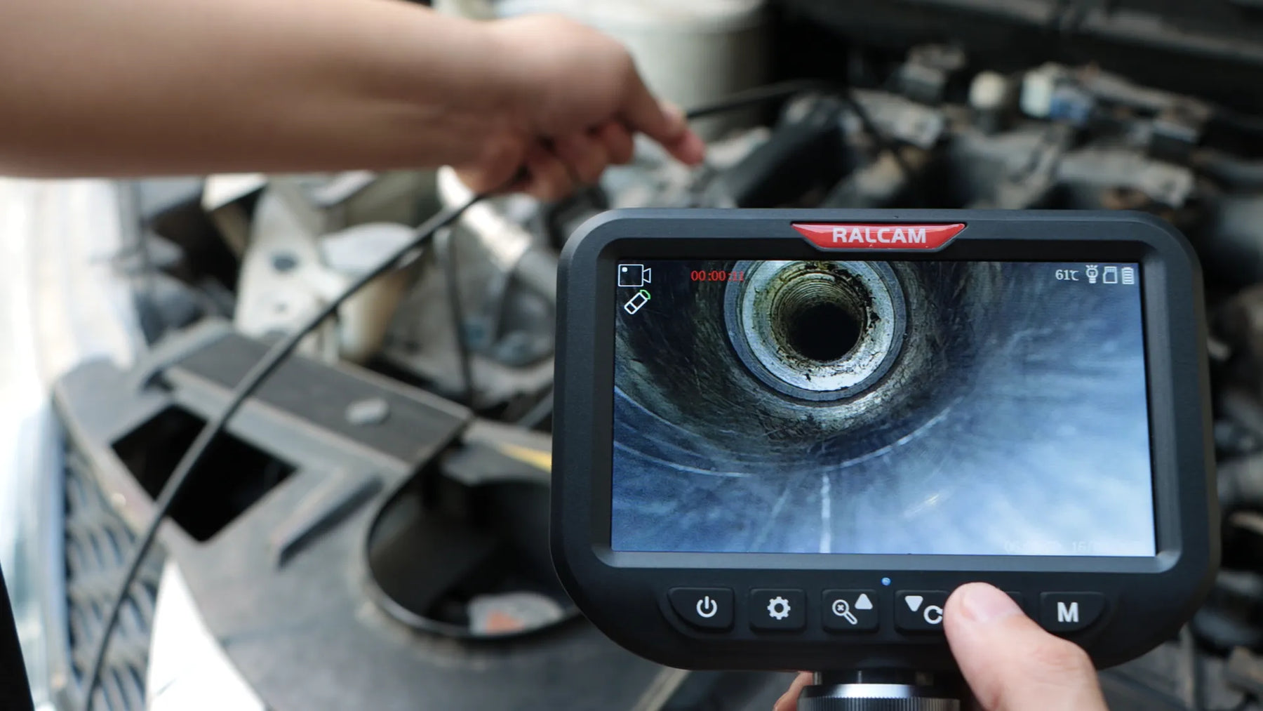 Borescope probe inserted through spark plug hole for engine cylinder inspection