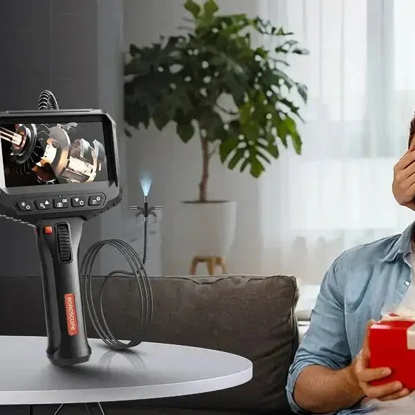 Caller inspection camera with monitor on table, carrying case, and couple at home with gift box