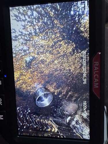Borescope screen showing a threaded fitting inside an oily cavity - customer photo